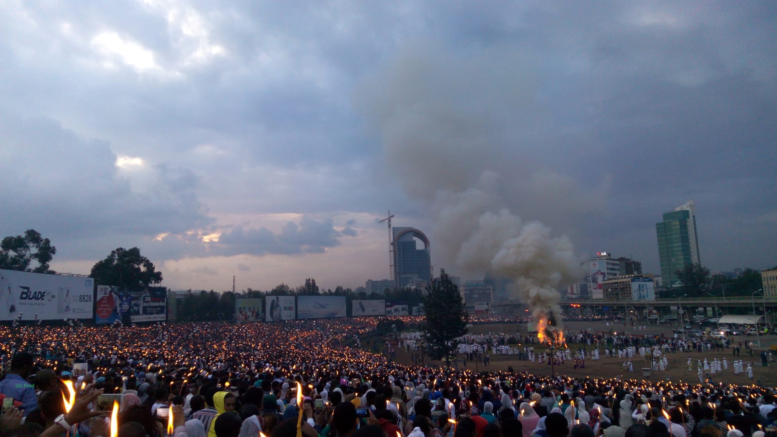 Crowds hold torches as smoke rises from the Demera bonfire at Meskel Square in Addis Ababa during Meskel celebrations. File photo from 2016, not from this year's 26-27 September 2026 celebration.