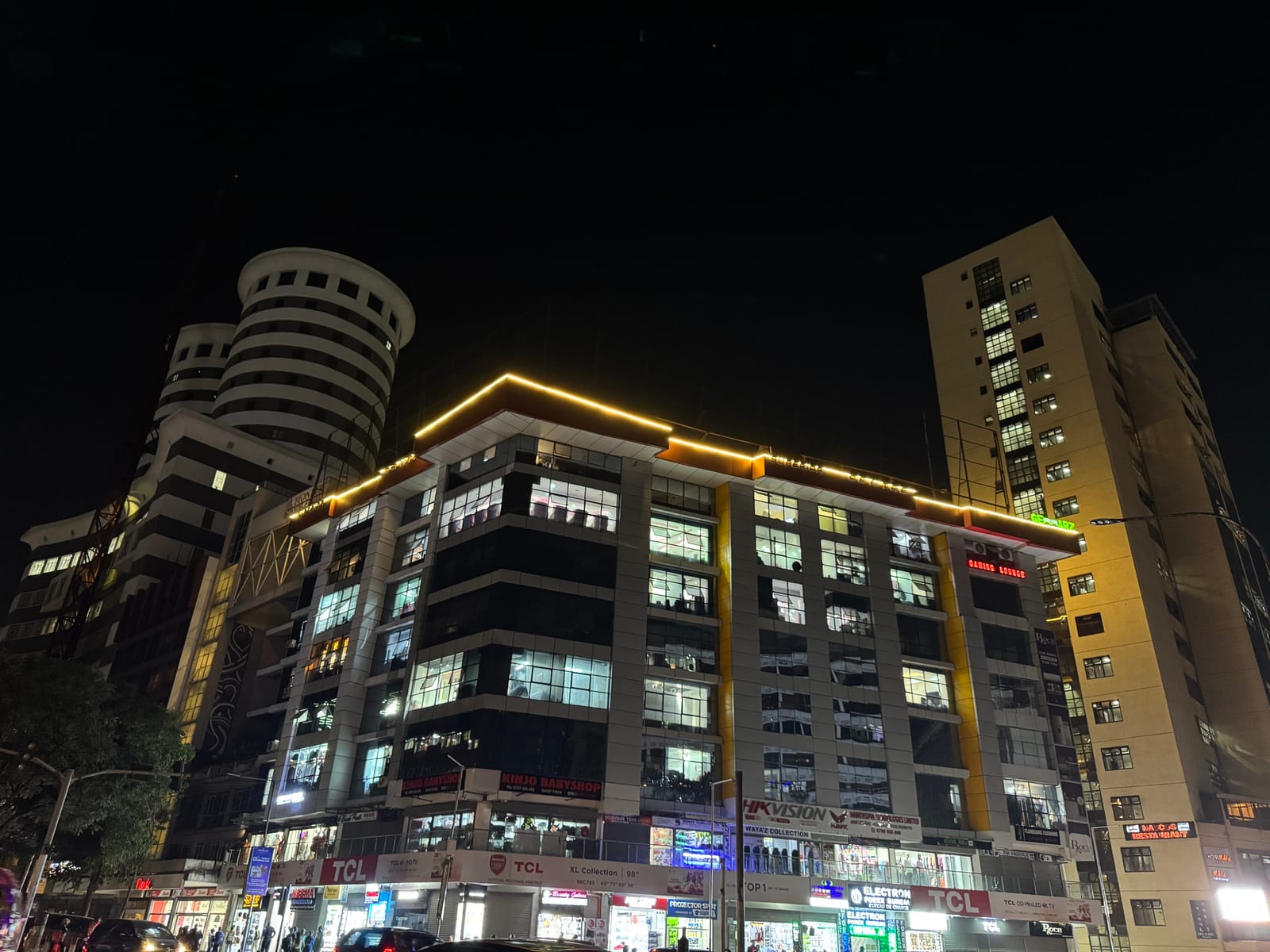 Lit office and commercial buildings along Kimathi Street, Nairobi CBD, at night (file photo, 2025).